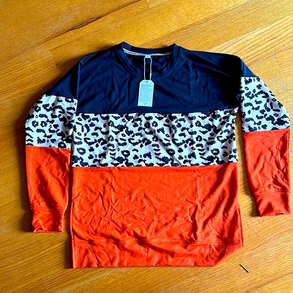 New with tags!Non smoking home.Tunic style sweater with small slits in hip area